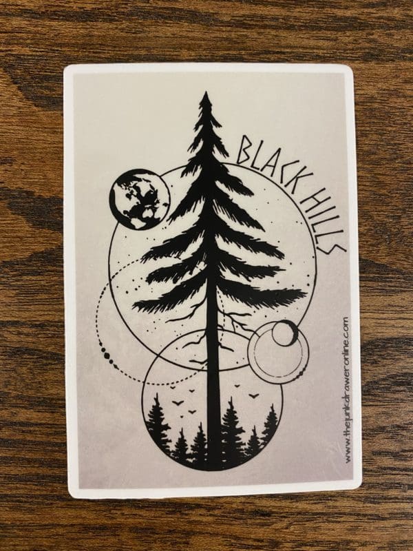 Black Hills sticker with a circular design and a large tree as the focal point