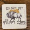 Do Not Pet the Fluffy Cows South Dakota sticker with a buffalo with the sun and hills being it design