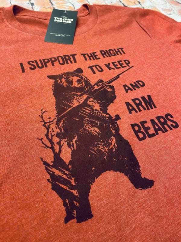 Close up of the I support the right to keep and arm bears text above a bear holding a rifle with an ammo sash