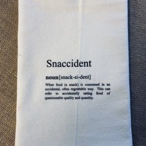 Custom towel with Snaccident text and definition below it explaining when food is consumed in an accidental way