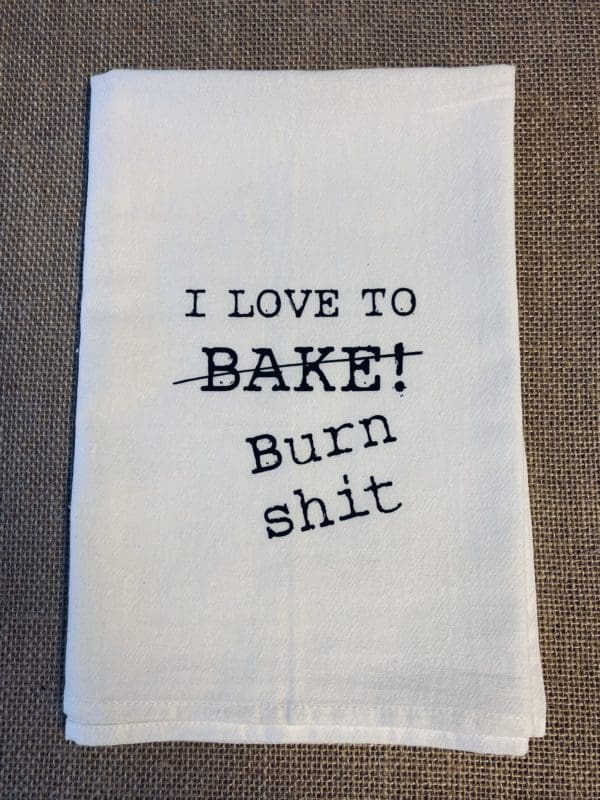 Custom towel with I love to BAKE! with BAKE! text crossed out above angled Burn shit text