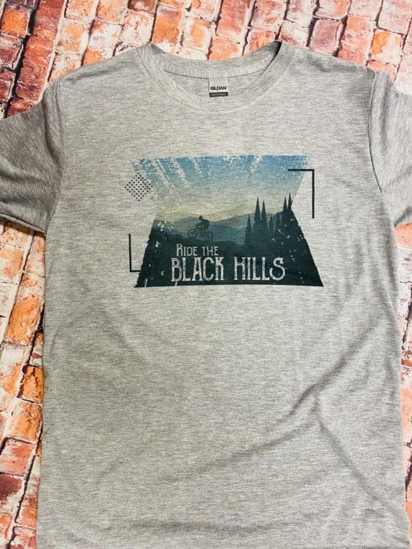Full view of ride the black hills t-shirt design on a brick background