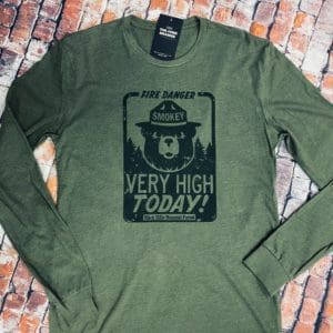 Black Fire Danger sign with Smokey the Bear and Very High Today! above Black Hills National Forest on a green long sleeve t-shirt