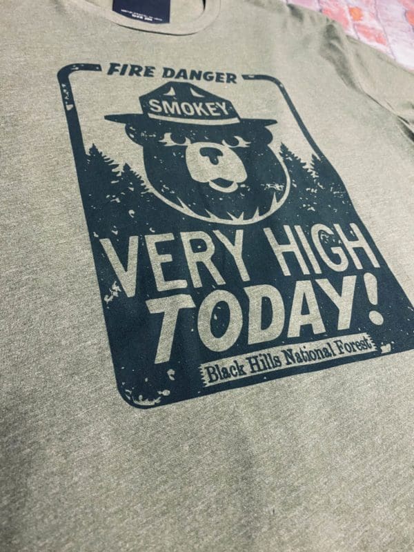 Black Fire Danger sign with Smokey the Bear and Very High Today! above Black Hills National Forest on a long sleeve t-shirt