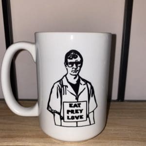 Custom mug with a drawn image of Jeffery Dahmer wearing a Eat Prey Love sign