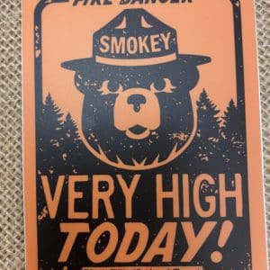 Orange Fire Danger sign with Smokey the Bear and Very High Today! above Black Hills National Forest sticker