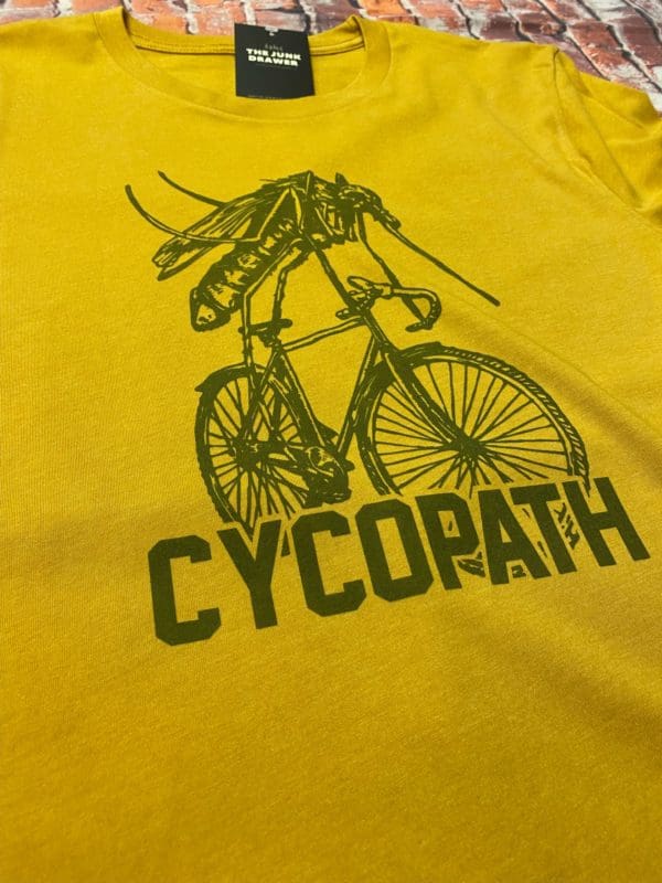Close up of the t-shirt design with a mosquito riding a bicycle above the text cycopath